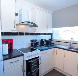 A kitchen with stove, sink, and refrigerator at 226 Third Avenue in Bridlington