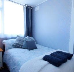 A bedroom with a bed and bedside table at 226 Third Avenue in Bridlington