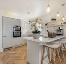 A kitchen with cabinets and a coffee machine at 6 Tegafan Abergele