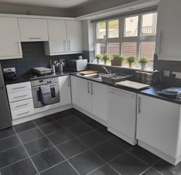 A kitchen with appliances and countertop at 17 Castleview in Ballymena
