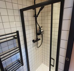A shower with a towel rack and tiles at Cullinview Isle of Skye