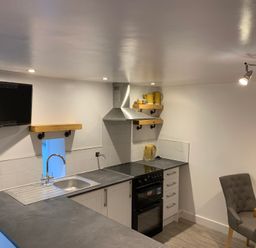 A kitchen with appliances and seating at The Haven in Penrith
