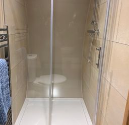 A shower and toilet in a bathroom at Cosy Escape in Sheerness