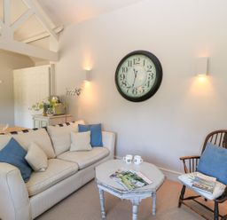 A living room with a sofa and armchair at Foxhill Farm Barn in Cheltenham