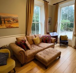 A living room with a sofa and window at Fountain Hill House Londonderry