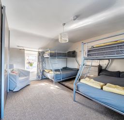 A bedroom with bunk beds and a double bed at Sea view cottage in Penmaenmawr