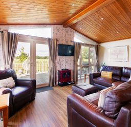 A living room with a television and seating at Hedgehog Lodge in York