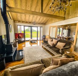 A living room with a sofa and television at Fox Lodge in York