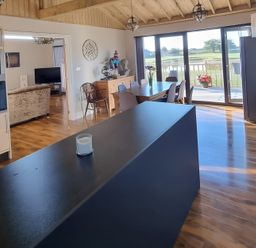 A kitchen with a large island and dining area at Fox Lodge in York