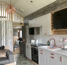 A kitchen with a sofa and dining area at Inverness Lodge in Inverness