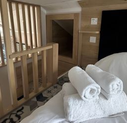 A bedroom with towels on the bed at Inverness Lodge in Inverness