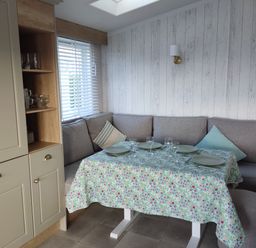 A dining area with a table set for meals at Harbour View in Poole