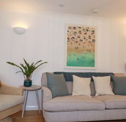 A living room with a sofa and artwork at Poldreth in Truro