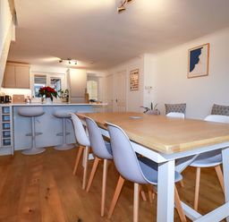 A dining room with a table and chairs at Poldreth in Truro
