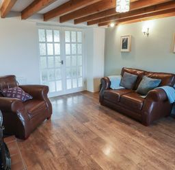 A living room with sofas and a coffee table at Rhosgranog Cottage Llandeloy near Solva