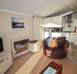 A living room with a television and fireplace at Rhosgranog Caravan Llandeloy near Solva