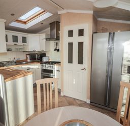 A kitchen with a refrigerator and oven at Rhosgranog Caravan in Llandeloy near Solva