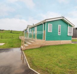 A mobile home with decking and steps at No 8 Hillcote Lodge in Cockermouth