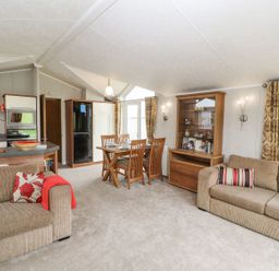 A living room and kitchen area at No 8 Hillcote Lodge in Cockermouth