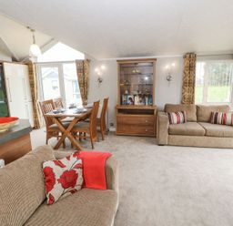A living room with a dining area at No 8 Hillcote Lodge in Cockermouth