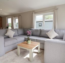 A living room with a sofa and coffee table at The Oaks 2 Bedrooms Delamere