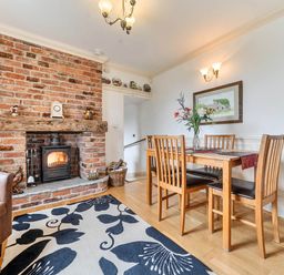 A dining room with a wooden table and chairs at Bank House Cottage in Glasson Dock