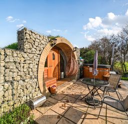 An outdoor area with a hot tub and seating at Cosy Escape Minster On Sea