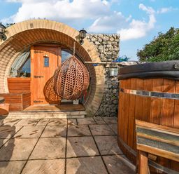 An outdoor area with a door and a hot tub at Cosy Escape in Minster On Sea