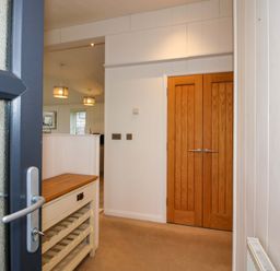 An entryway with a cupboard and doors at 5 Hillview Lodges Cleobury Mortimer