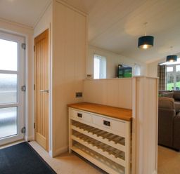 An entrance area with a wine rack and a television at 5 Hillview Lodges in Cleobury Mortimer