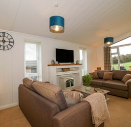 A living room with a television and sofa at 5 Hillview Lodges in Cleobury Mortimer