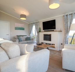 A living room with a sofa and television at Moorland View