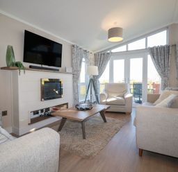 A living room with a television fireplace and sofa at Moorland View