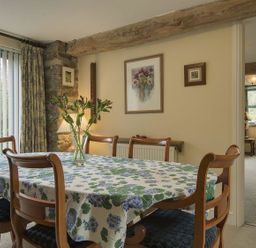A dining room with a table and chairs at Pillars in Barnstaple