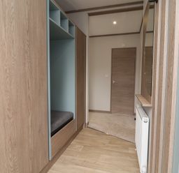 A hallway with a wardrobe and a bench at Cedar Lodge 3 Bedrooms with hot tub Delamere
