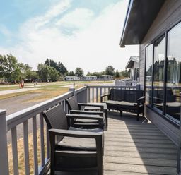 A deck with chairs at Cedar Lodge 3 Bedrooms with hot tub Delamere
