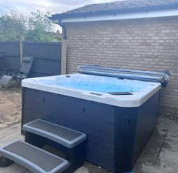 A hot tub with steps beside lawn chairs at 43 Goose Green Road King's Lynn