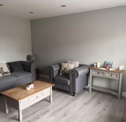 A living room with sofas and a coffee table at 43 Goose Green Road in King's Lynn