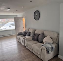 A living room with a sofa and window at 15 Lamsey Lane in King's Lynn