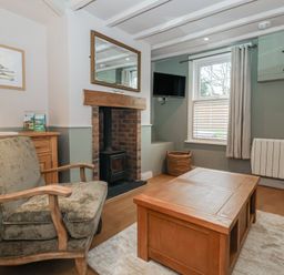 A living room with a fireplace and armchair at No.4 Main Street in Hull