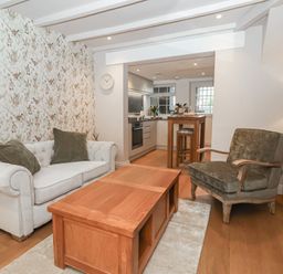 A living room with a sofa and a table at No.4 Main Street, Hull