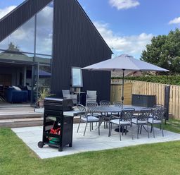 An outdoor seating area with a barbecue grill and table at The Barn in Longframlington