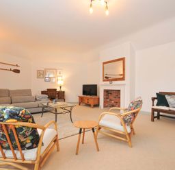 A living room with a sofa and chairs at Cribba in Port Isaac