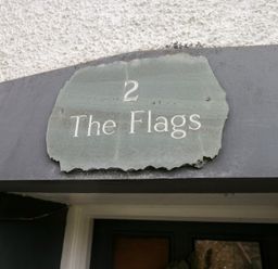 A sign reading 2 The Flags at the entrance of the property No.2 The Flags, Grange-over-Sands