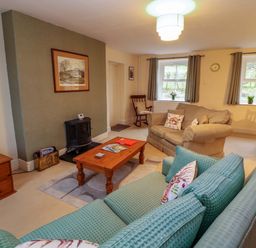 A living room with sofa and coffee table at Easthwaite Cottage in Holmrook near Easthwaite Farm
