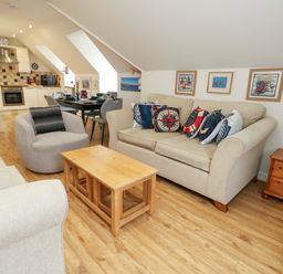 A living room with a sofa and coffee table at Flat 7 Weymouth