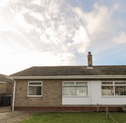 A bungalow exterior with windows at Megstone in Chathill