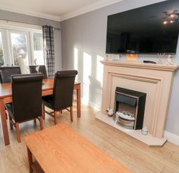A dining room with a table and chairs at Megstone in Chathill