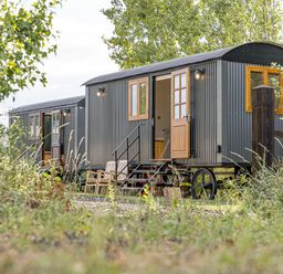 Two shepherd's huts with steps and garden benches at No 2 The Parkland Upton Warren