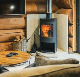 A living room with a stove and coffee table at The Lookout in Addingham